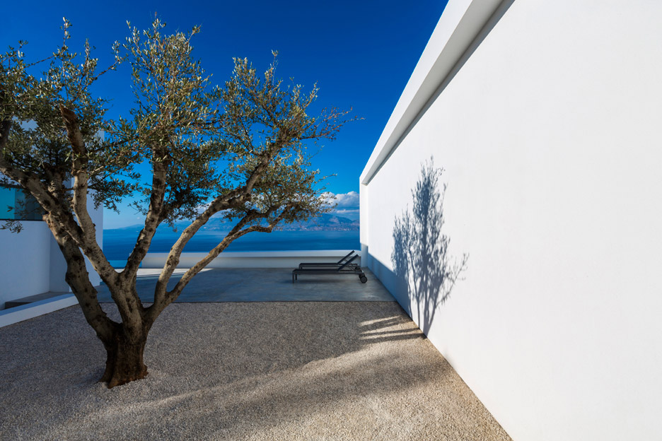 Stark white walls frame vistas of the Ionian Sea from a bright white house by Brussels-based architect Olivier Dwek.
